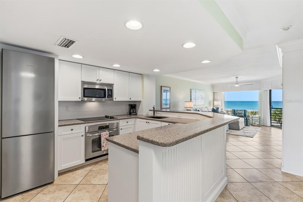 5000 Gasparilla Road, Unit BC306 Boca Grande, FL 33921 - Photo 6 of 35 a kitchen with stainless steel appliances granite countertop a sink stove and refrigerator
