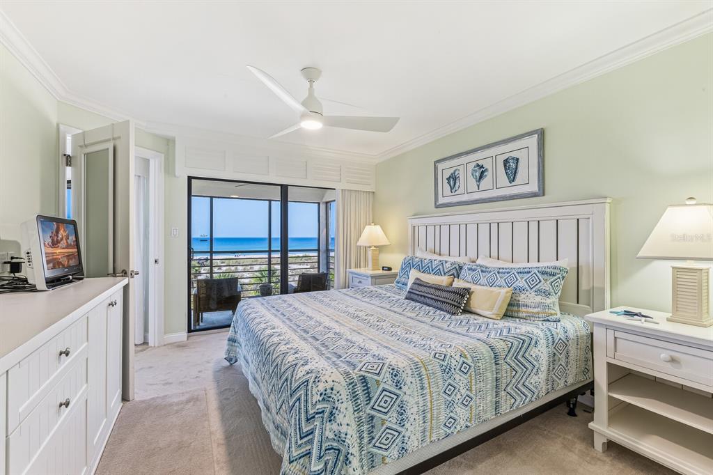 5000 Gasparilla Road, Unit BC306 Boca Grande, FL 33921 - Photo 9 of 35 a bedroom with a large bed and a chandelier