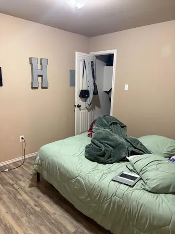 a bedroom with a bed and a couch