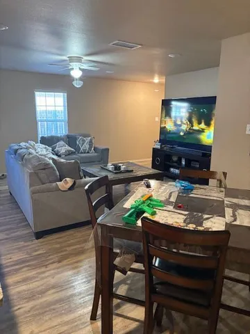 a workspace with furniture and a wooden floor