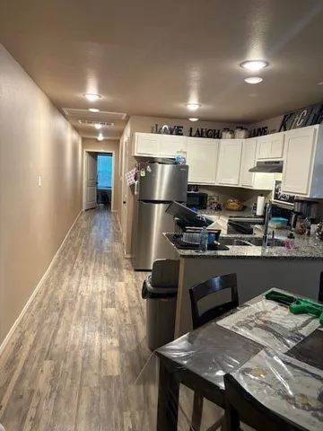a bathroom with a granite countertop sink a toilet and a mirror