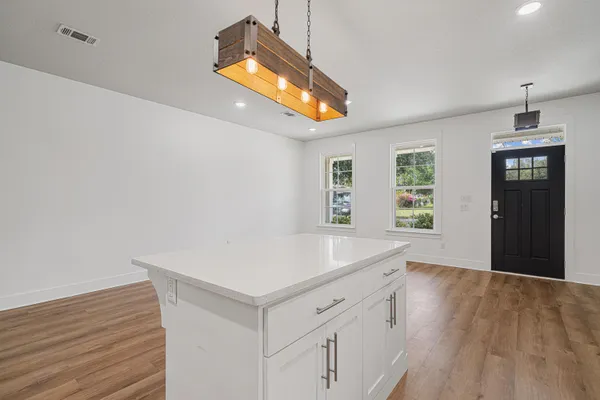 a kitchen with a sink a microwave a stove and refrigerator