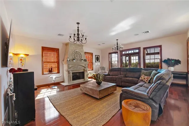 a living room with furniture ceiling fan and a flat screen tv