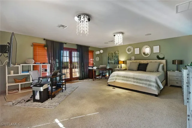 a bed room with furniture and a chandelier