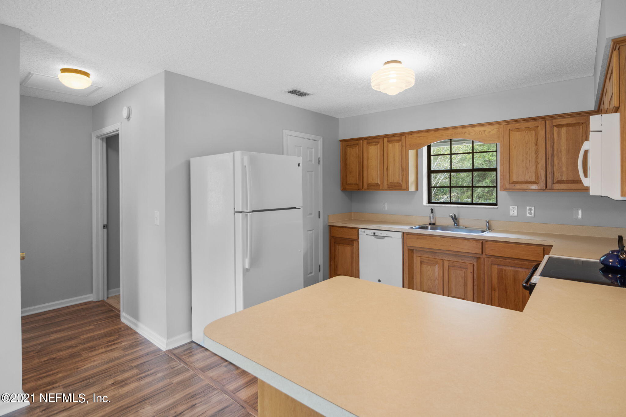 736 Halsema Road North Jacksonville, FL 32220 - Photo 12 of 29 a kitchen with granite countertop a refrigerator and a sink