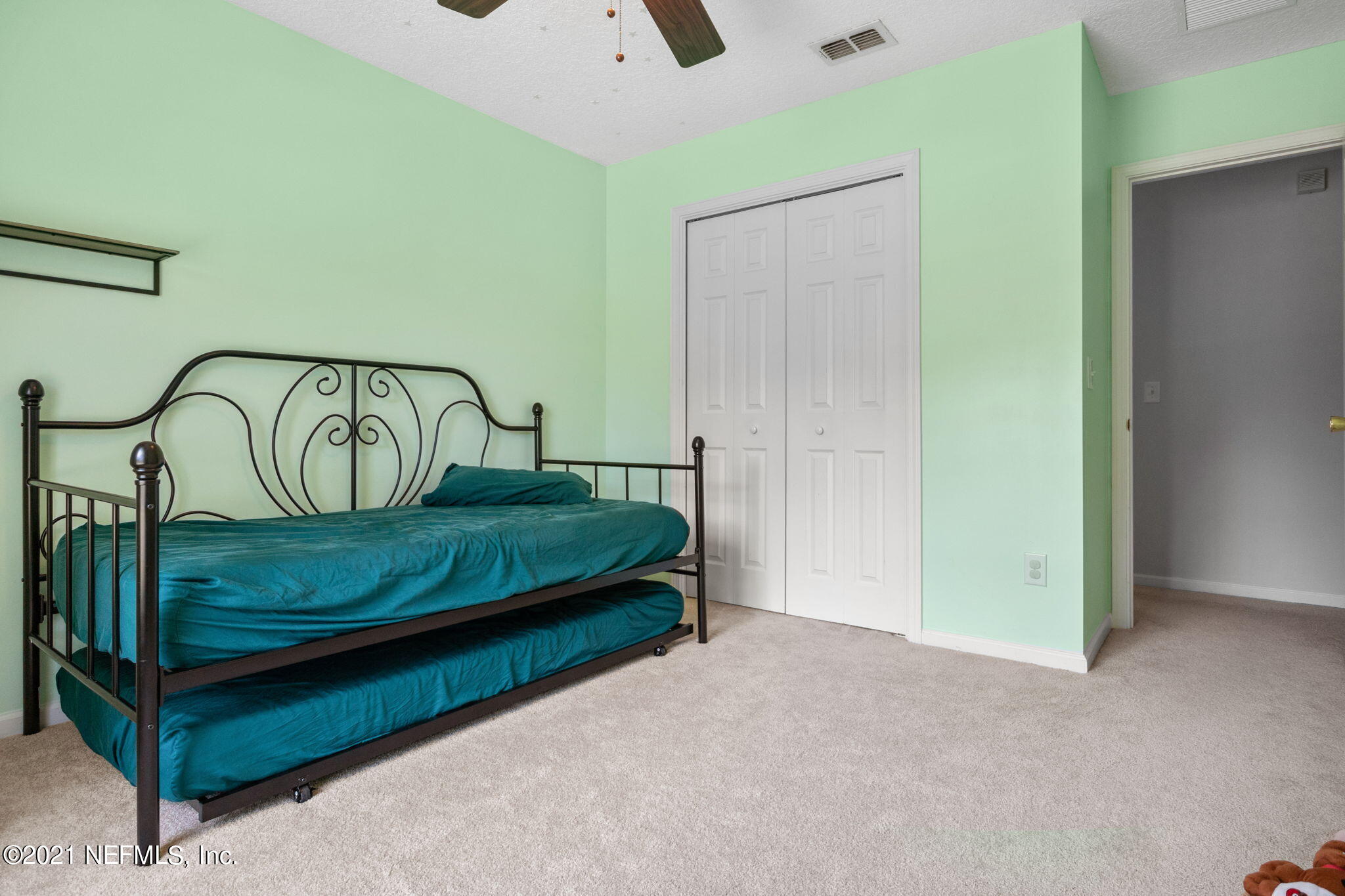 736 Halsema Road North Jacksonville, FL 32220 - Photo 19 of 29 a bedroom with a bed and a table