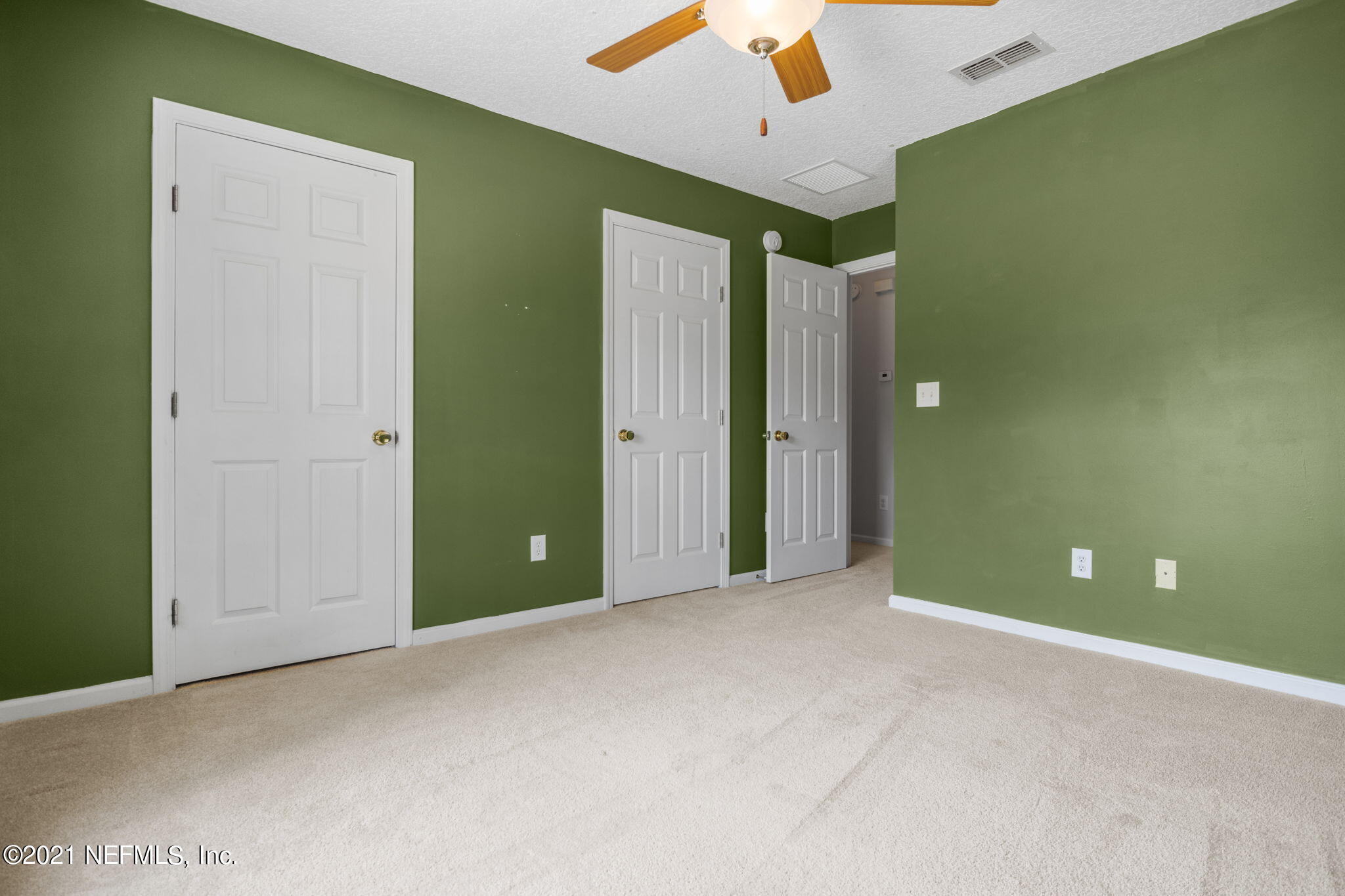 736 Halsema Road North Jacksonville, FL 32220 - Photo 22 of 29 an empty room with closet and fan