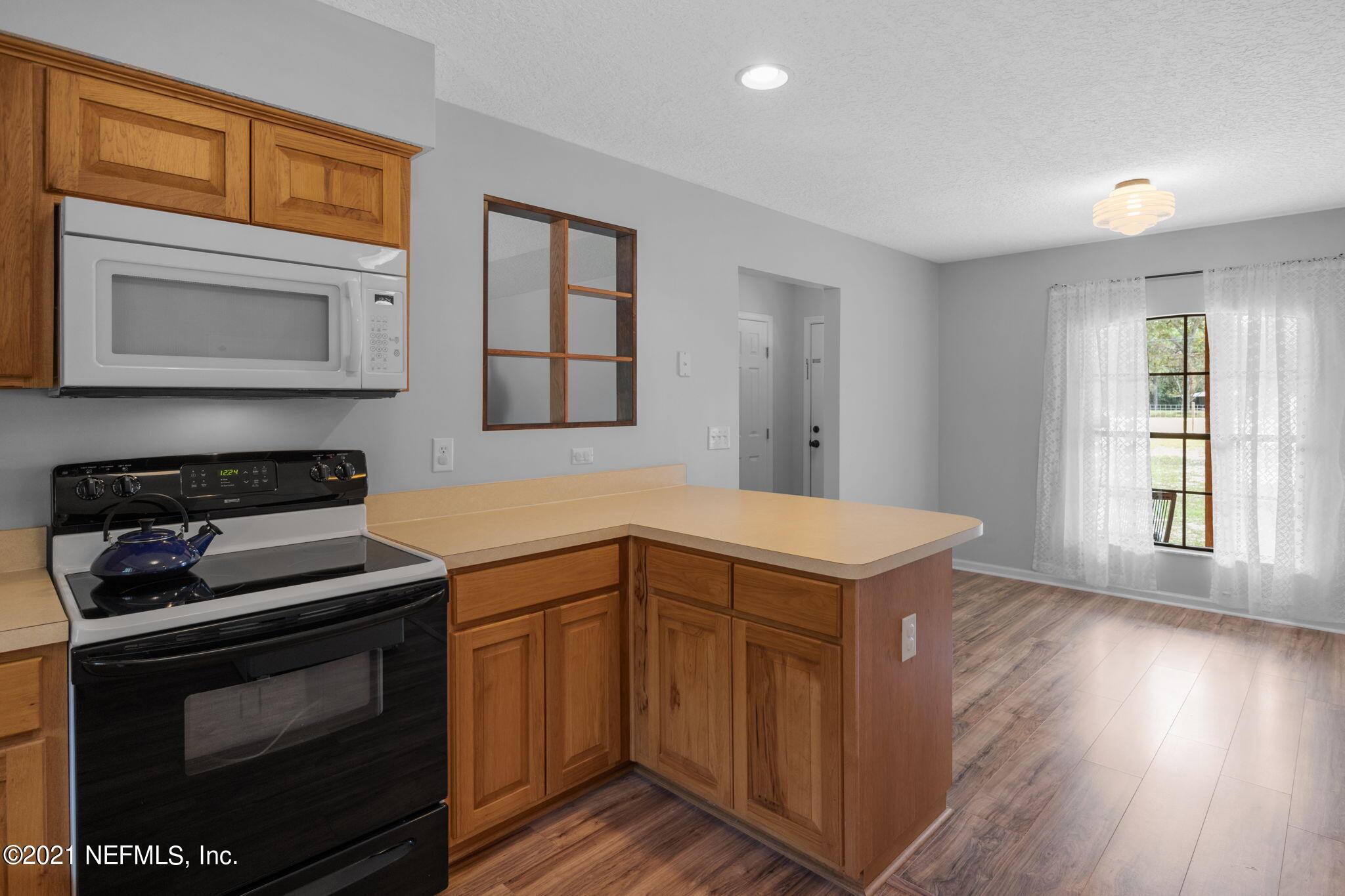 736 Halsema Road North Jacksonville, FL 32220 - Photo 8 of 29 a kitchen with stainless steel appliances granite countertop a stove and a microwave