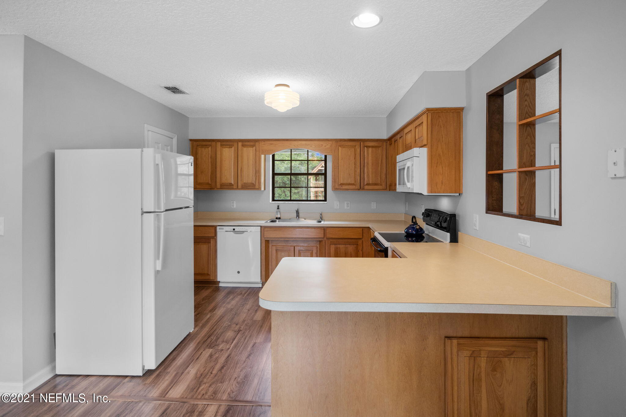 736 Halsema Road North Jacksonville, FL 32220 - Photo 9 of 29 a kitchen with stainless steel appliances granite countertop a sink stove and refrigerator