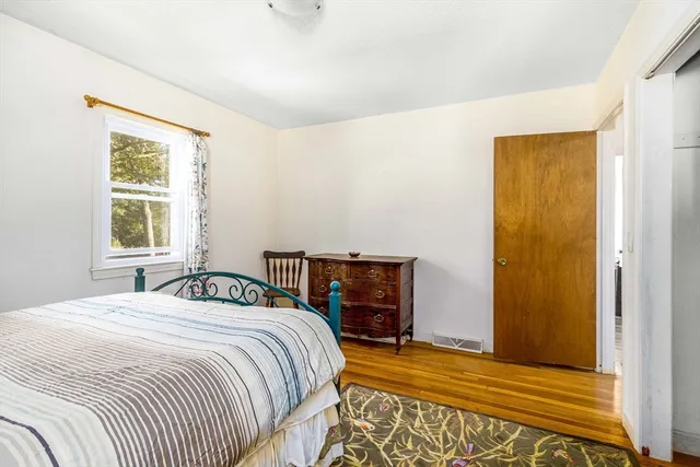 a bed room with a bed and a chair