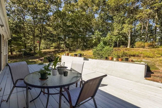 a view of a house with pool and sitting area