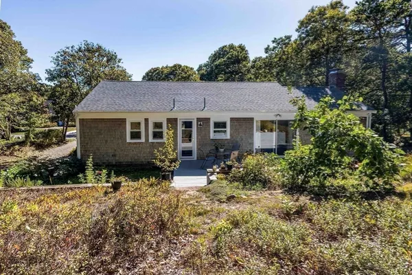 a view of a house with a yard and tree s