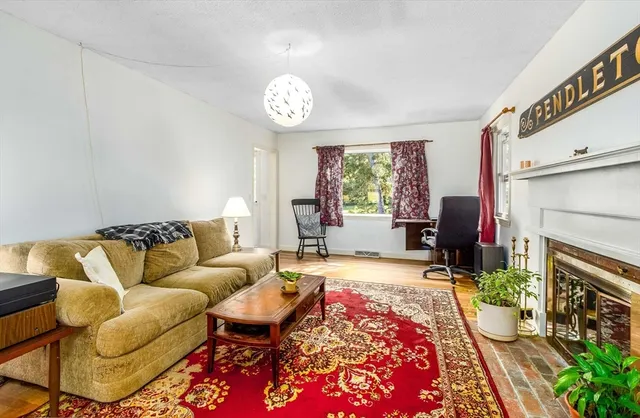 a living room with furniture a window and a fireplace