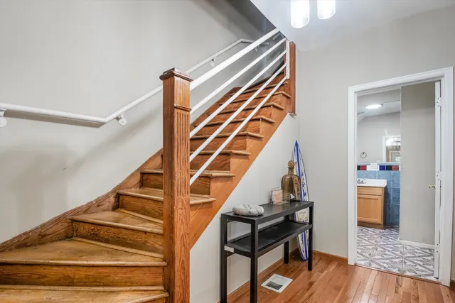 a view of entryway and hall with wooden floor