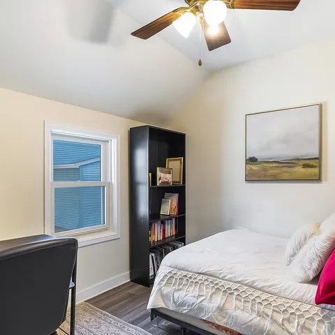 a bedroom with a large bed and a window