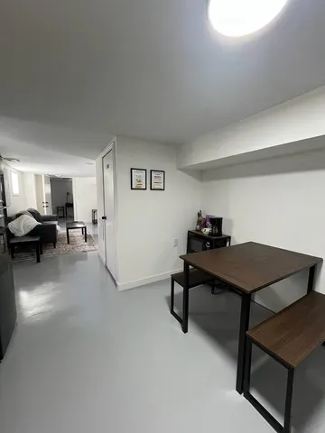 a living room with furniture a table and gym equipment