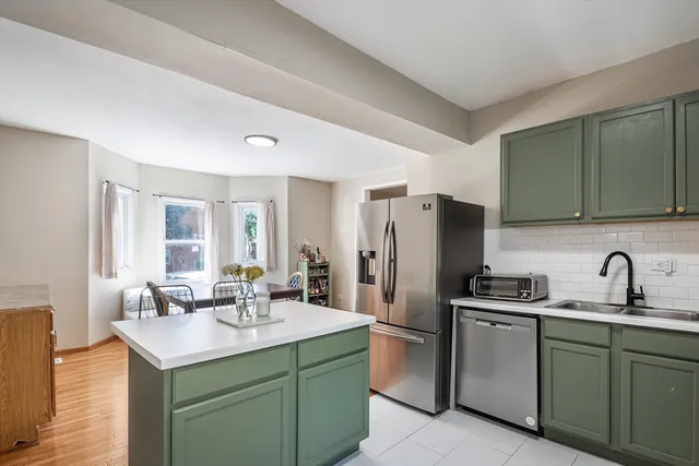 a kitchen with a sink cabinets and refrigerator