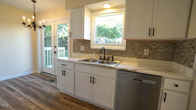 a kitchen with sink cabinets and window
