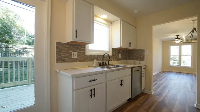 a kitchen with a sink cabinets and window