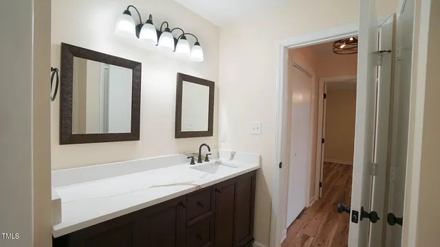 a bathroom with a sink vanity and a mirror