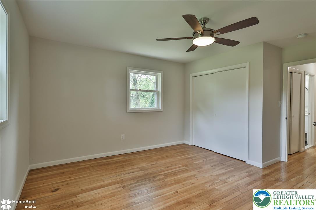 919 Point Phillips Road Bath, PA 18014 - Photo 39 of 59 A well-lit bedroom features lustrous hardwood flooring and a functional ceiling fan.