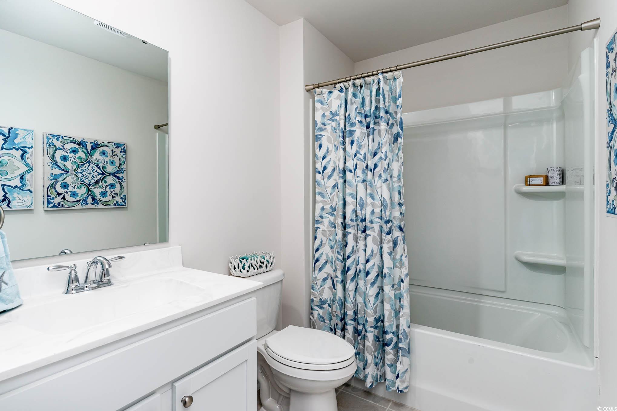 1014 Ridgeford Drive Conway, SC 29526 - Photo 21 of 32 Bathroom featuring vanity, shower / bath combo with shower curtain, and tile patterned flooring