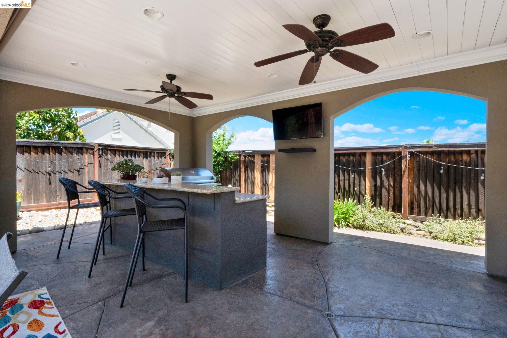 2513 Winged Foot Road Brentwood, CA 94513 - Photo 34 of 45 Covered outdoor living space featuring an integrated outdoor kitchen with a built-in grill and a stone-finish countertop