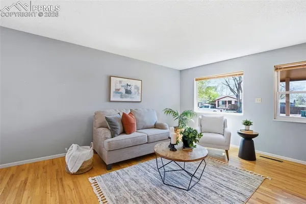 a living room with furniture and wooden floor
