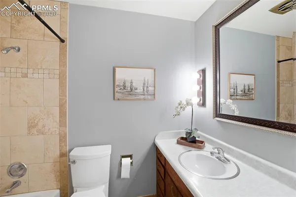 a bathroom with a sink toilet and a mirror