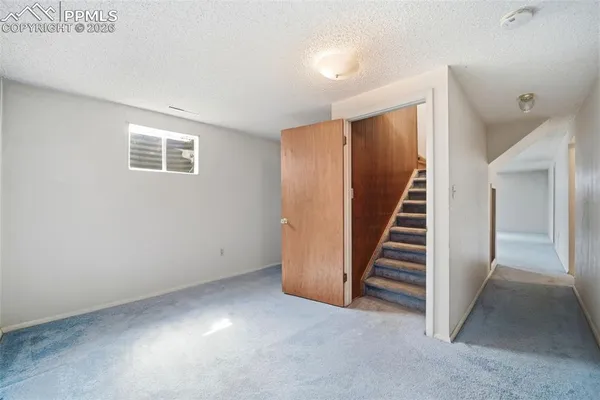 an empty room with fireplace and window