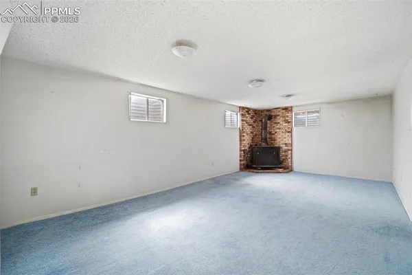 a view of an empty room with a fireplace