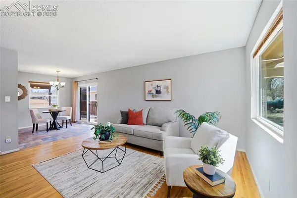 a living room with furniture and wooden floor