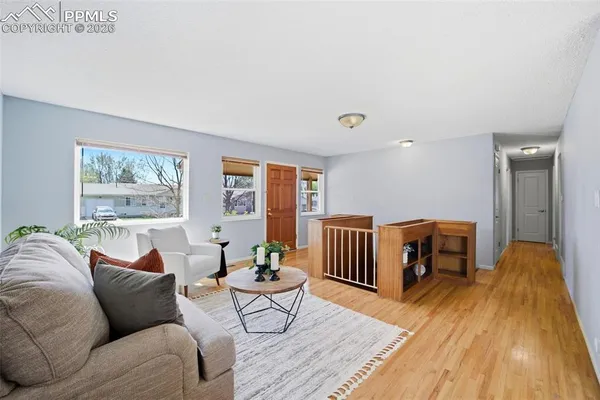 a living room with furniture and wooden floor
