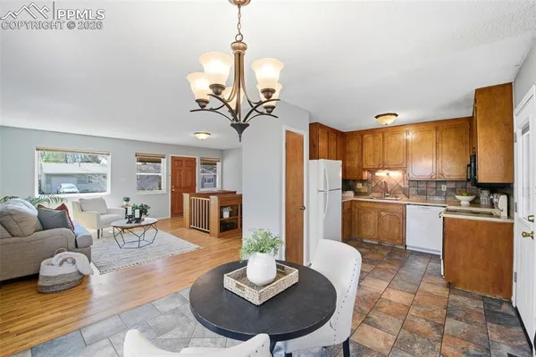 a living room with stainless steel appliances granite countertop furniture and a kitchen view