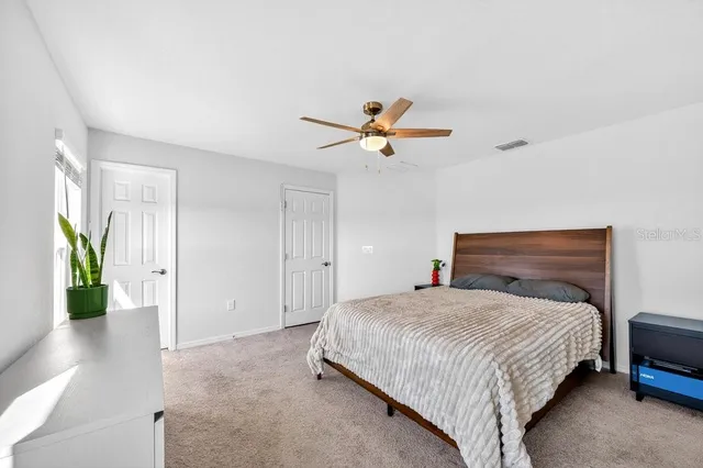 a bathroom with a sink toilet vanity and shower