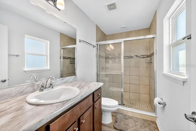 a bathroom with a glass shower door