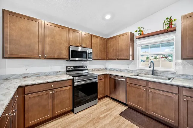a kitchen with kitchen island a counter space and stainless steel appliances