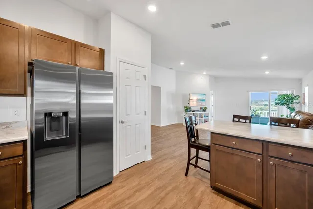 a kitchen with stainless steel appliances granite countertop a refrigerator and microwave