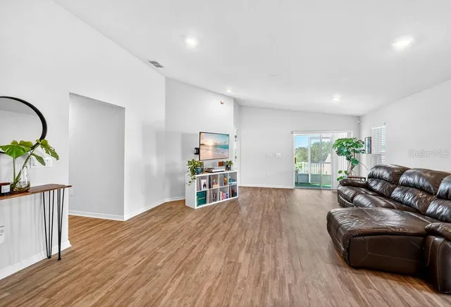 a living room with furniture and wooden floor