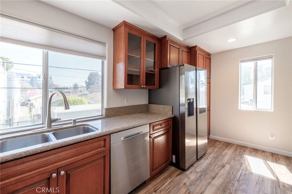 1128 Pacific Avenue Long Beach, CA 90813 - Photo 12 of 33 a kitchen with stainless steel appliances a refrigerator and a sink