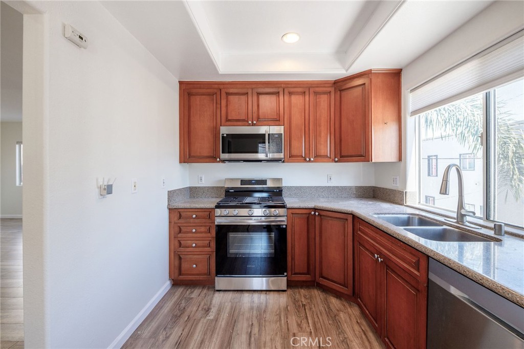 1128 Pacific Avenue Long Beach, CA 90813 - Photo 14 of 33 a kitchen with stainless steel appliances granite countertop a stove sink and cabinets