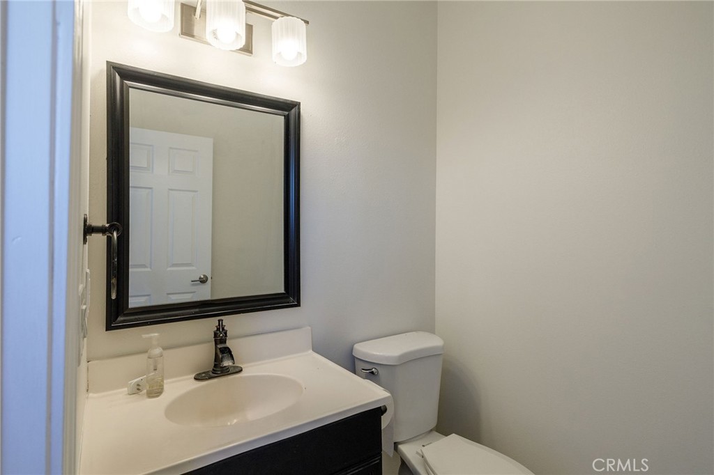 1128 Pacific Avenue Long Beach, CA 90813 - Photo 17 of 33 a bathroom with a toilet sink and mirror