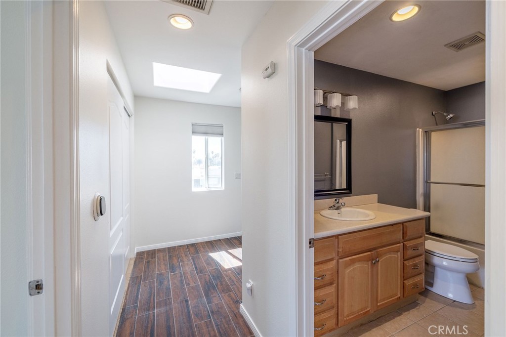 1128 Pacific Avenue Long Beach, CA 90813 - Photo 20 of 33 a bathroom with a sink a toilet and mirror