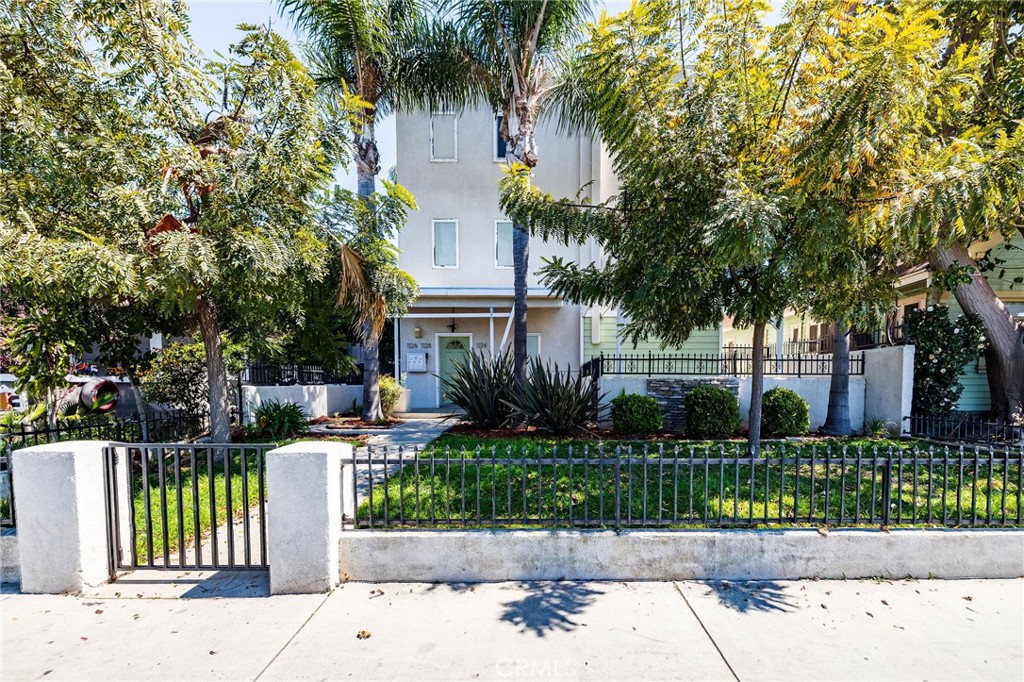 1128 Pacific Avenue Long Beach, CA 90813 - Photo 2 of 33 a front view of a house with a garden