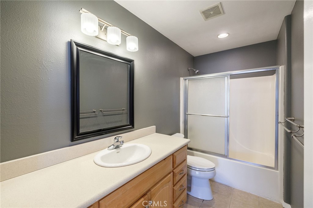 1128 Pacific Avenue Long Beach, CA 90813 - Photo 21 of 33 a bathroom with a granite countertop sink toilet and mirror