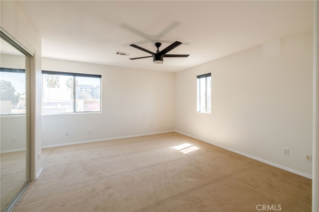 1128 Pacific Avenue Long Beach, CA 90813 - Photo 24 of 33 an empty room with windows and ceiling fan