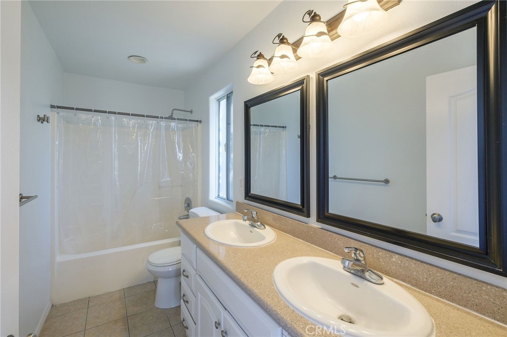 1128 Pacific Avenue Long Beach, CA 90813 - Photo 27 of 33 a bathroom with a sink double vanity granite tub and shower
