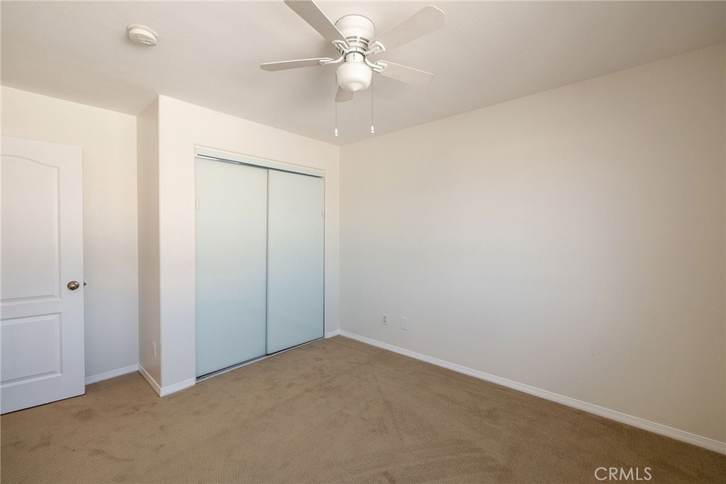 1128 Pacific Avenue Long Beach, CA 90813 - Photo 30 of 33 an empty room with a ceiling fan and a fan