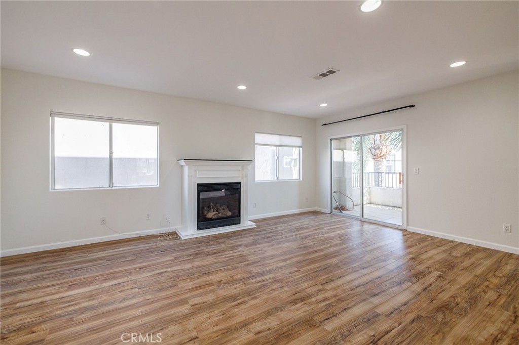 1128 Pacific Avenue Long Beach, CA 90813 - Photo 6 of 33 a view of an empty room with wooden floor and a window