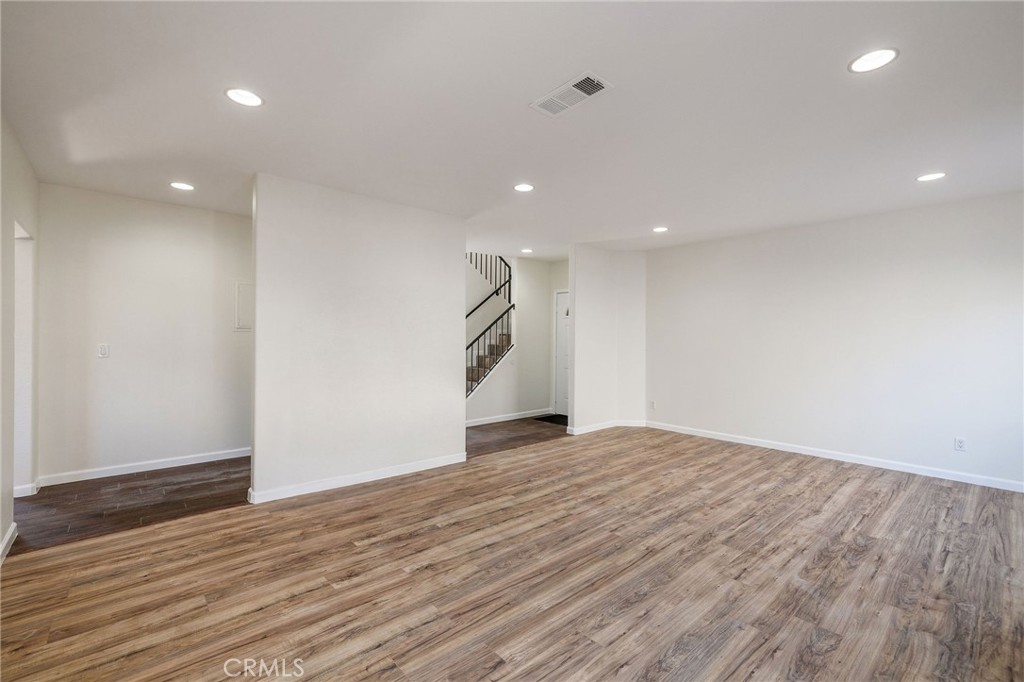 1128 Pacific Avenue Long Beach, CA 90813 - Photo 10 of 33 a view of an empty room with wooden floor and ceiling fan